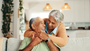 Your wife hugging her husband, happy that he received reverse shoulder replacement