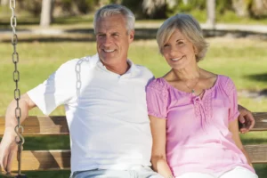 A Florida couple sitting on a porch swing after having relief from shoulder arthritis