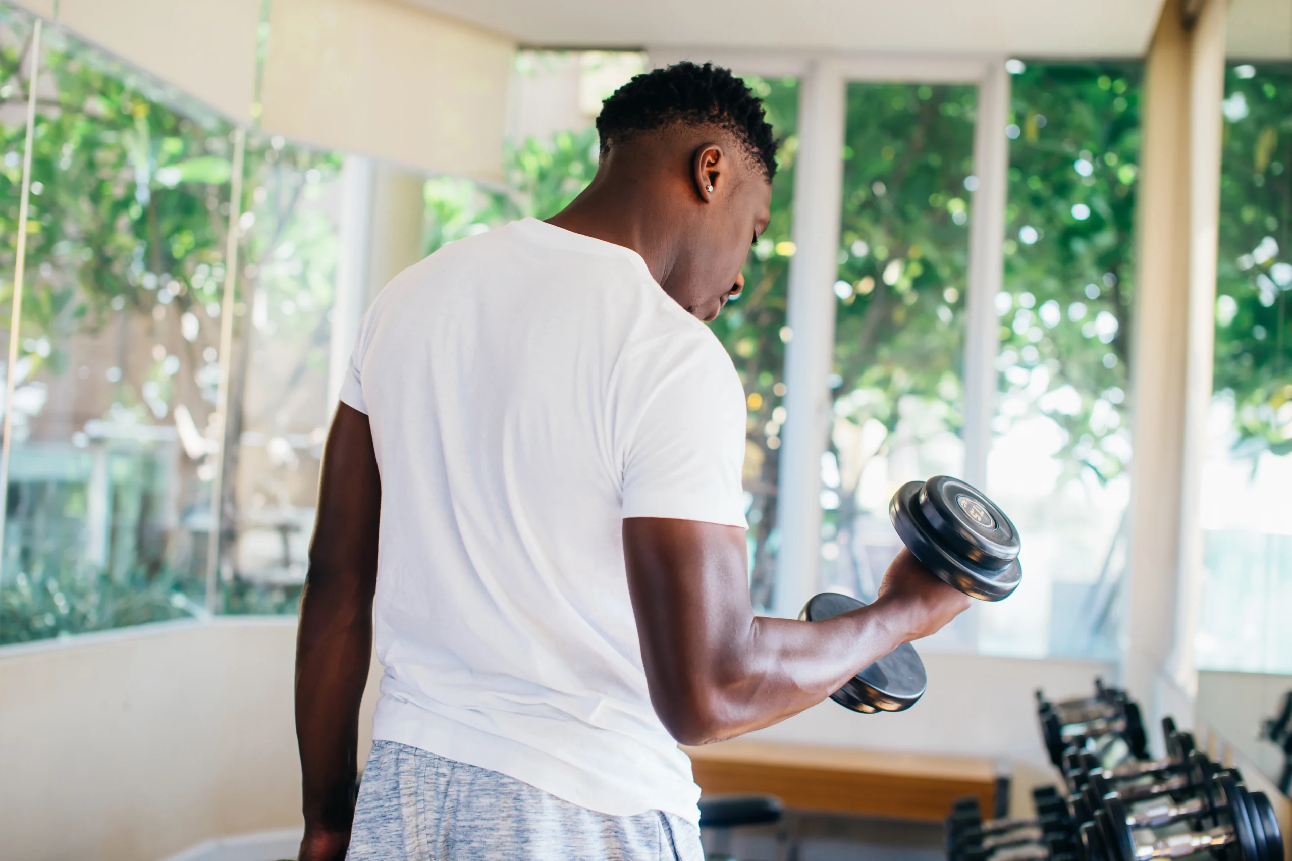 Patient experiencing shoulder pain as a result of lifting weights.