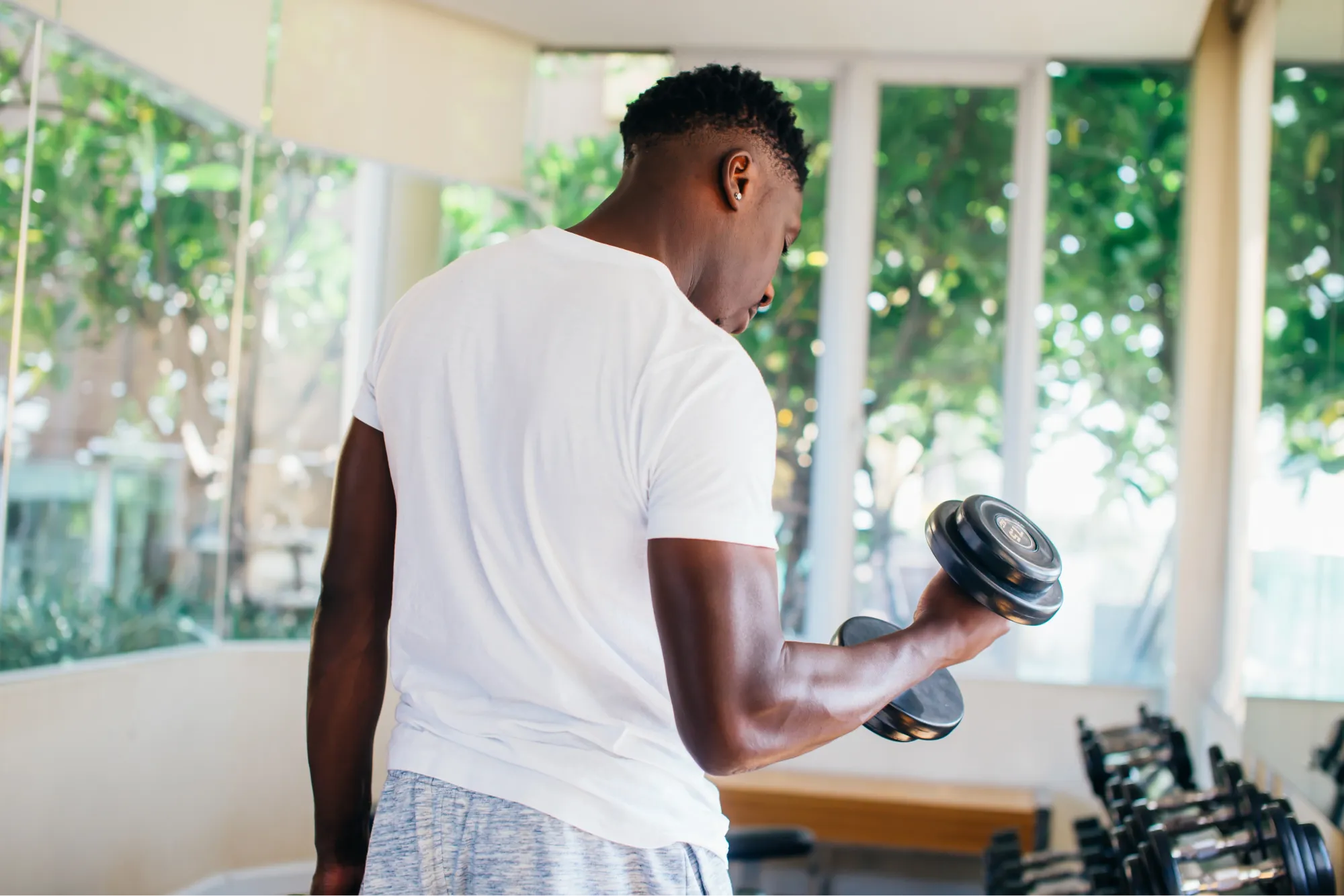 Patient experiencing shoulder pain as a result of lifting weights.