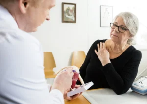 patient consulting with surgeon about shoulder surgery