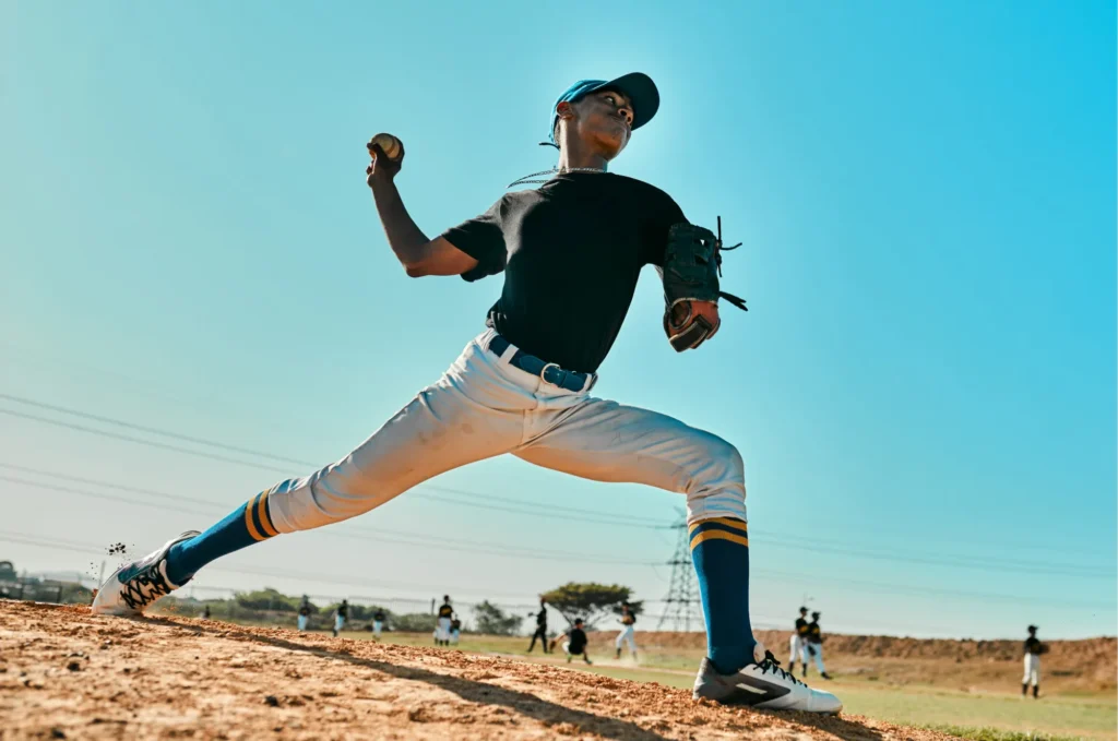 baseball-pitcher Baseball pitcher throwing a pitch from the mound during a game.